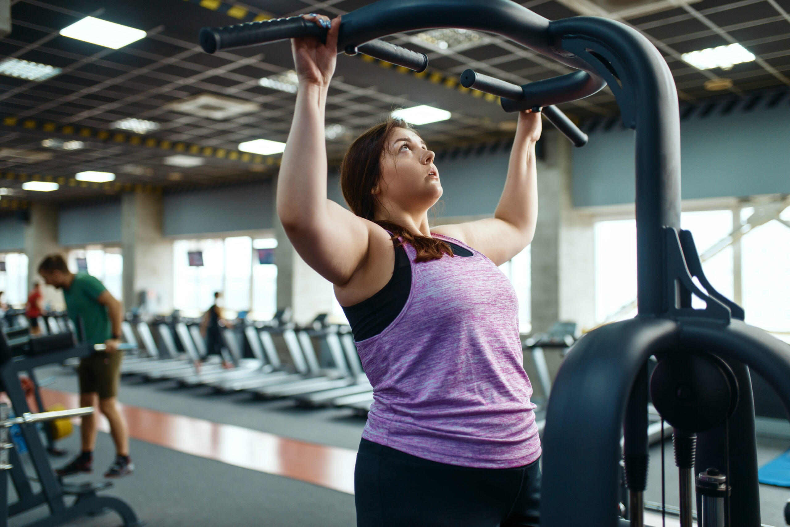 overweight woman on exercise machine in gym 2022 02 02 04 51 40 utc