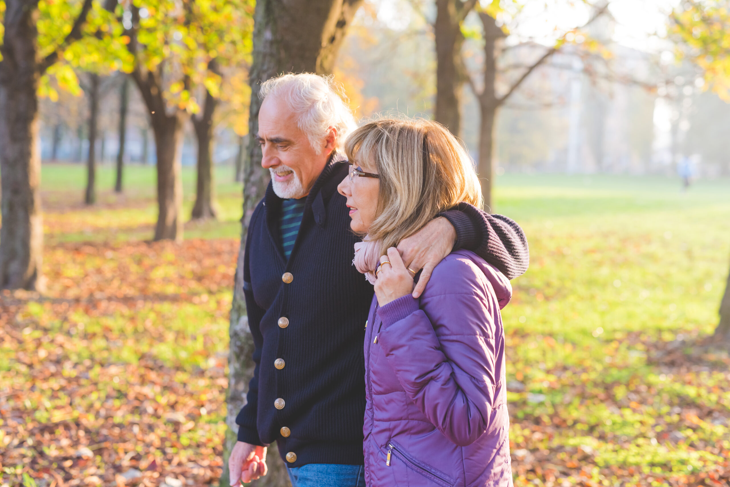 Middle age couple hugging outdoor backlight