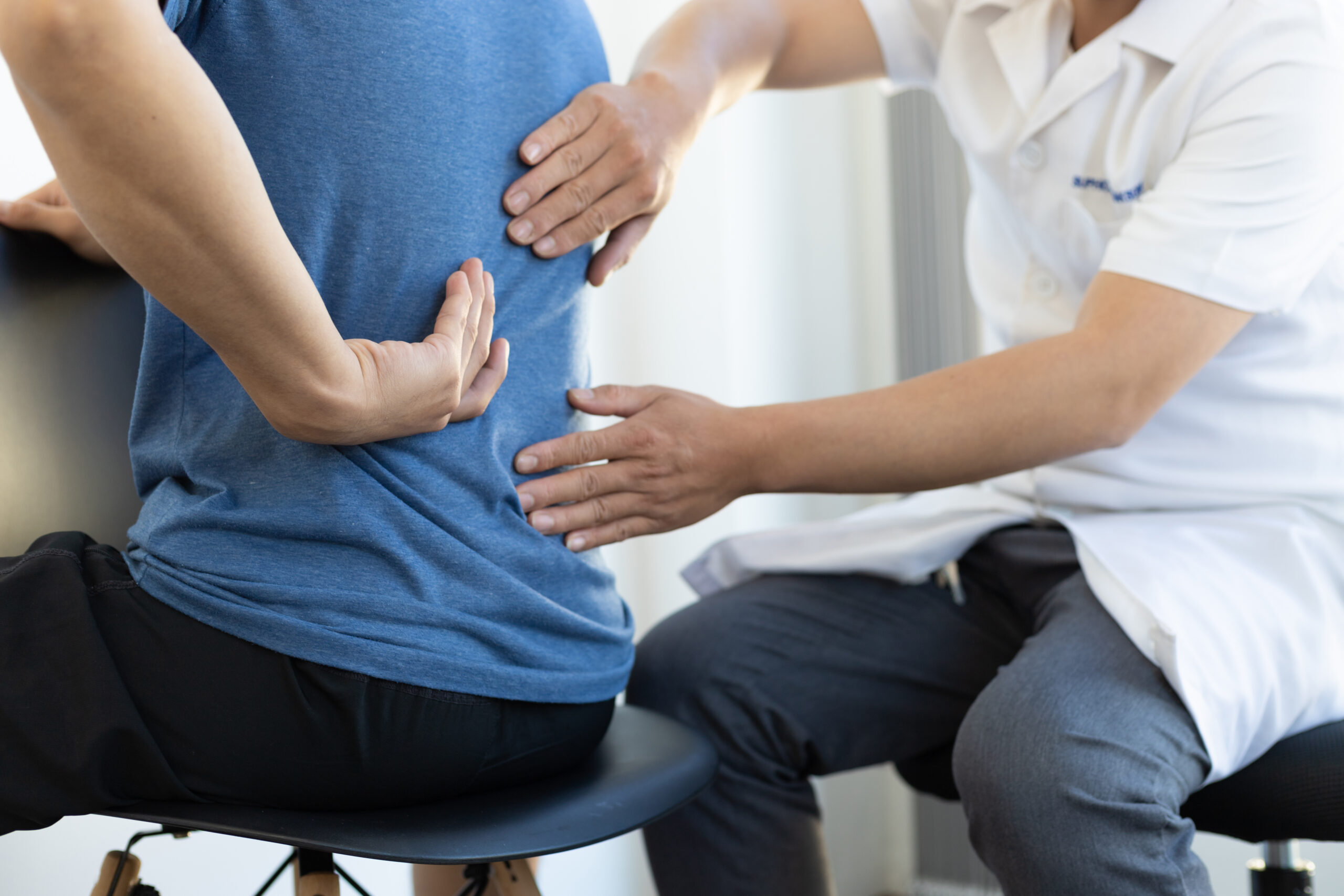 the doctor is diagnosing the patient s back pain 2023 04 10 23 16 42 utc